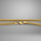 Gold chain necklace on a gray background