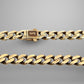 Gold chain bracelet on a gray background