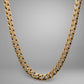 Gold chain necklace on a gray background