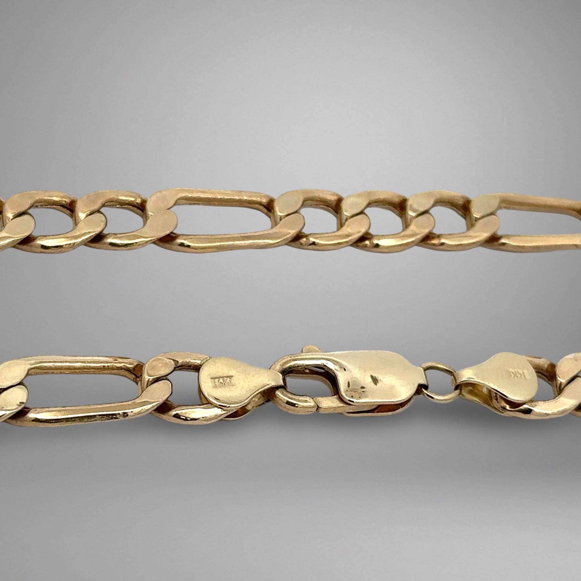 Gold chain on a gray background