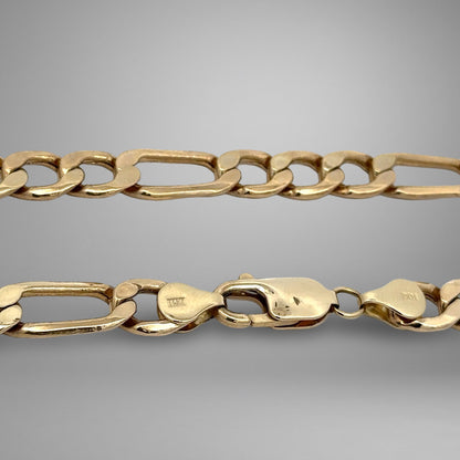 Gold chain on a gray background
