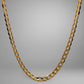 Gold chain necklace on a gray background