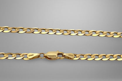 Gold chain with a clasp on a gray background