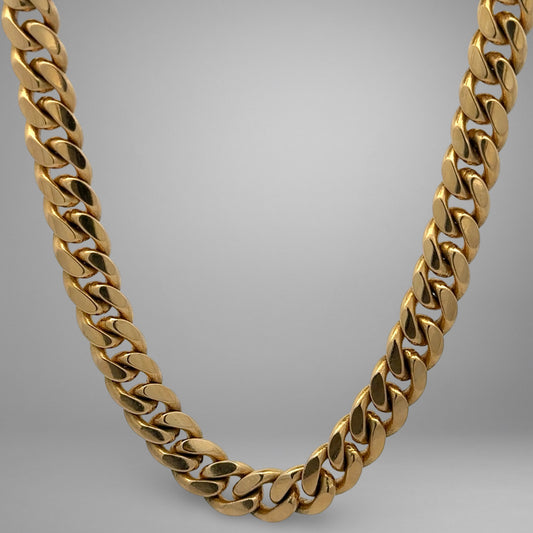 Gold chain necklace on a gray background