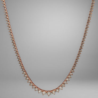 Rose gold necklace with diamonds on a gray background