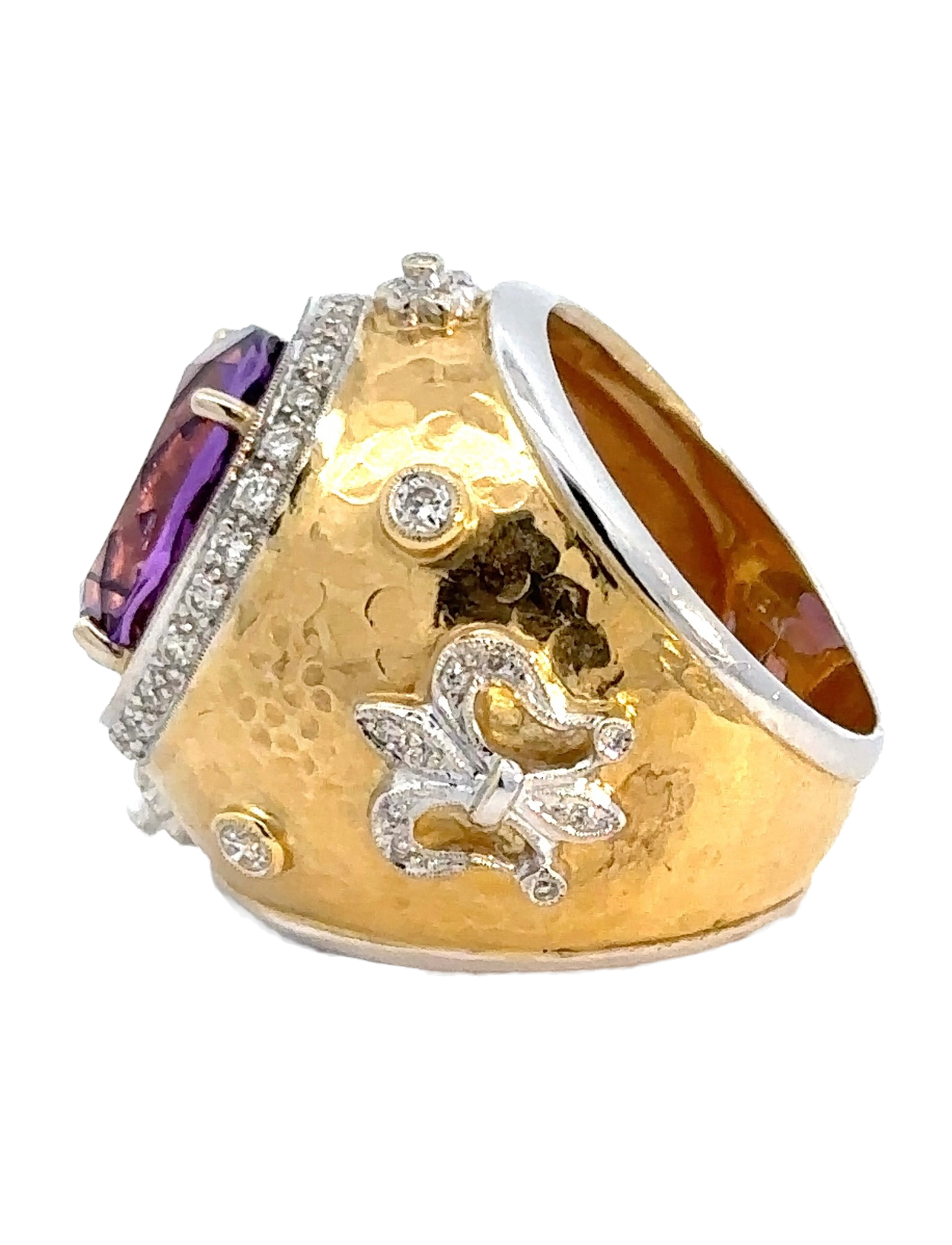 The side of the amethyst ring. Shows the 18K yellow gold and small diamonds. Some scratches shown.