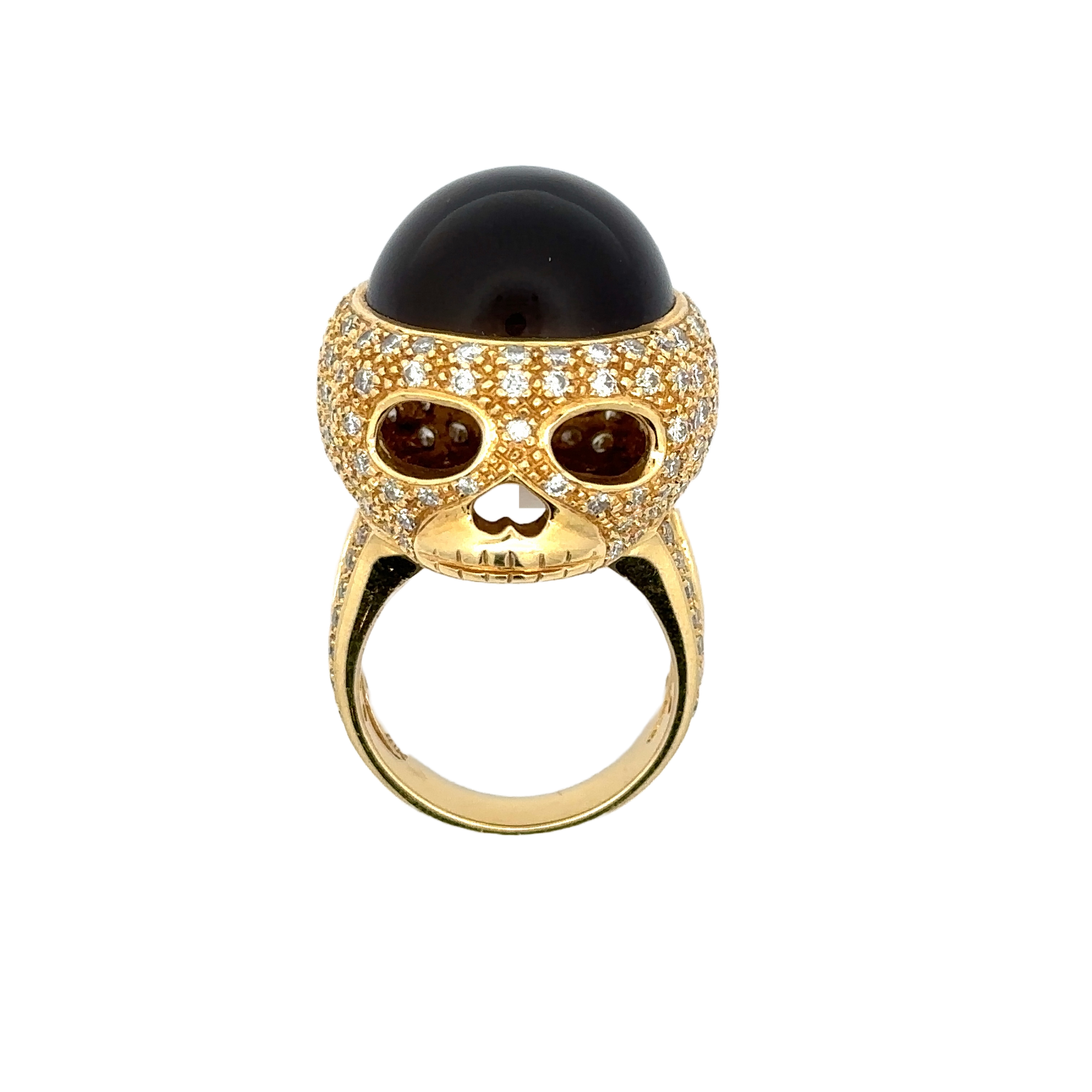 18K yellow gold cat's eye diamond skull ring. Shows the skull face of the ring. Some scratches on the band.