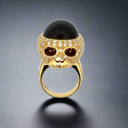 18K yellow gold cat's eye diamond skull ring. Shows the skull face of the ring. Some scratches on the band.