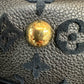 Scratches on gold buttons on bottom of bag