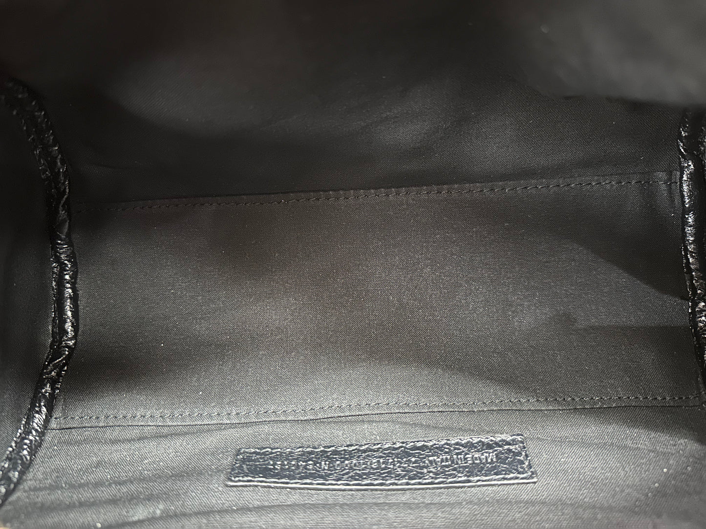 Close up of inside of black bag with serial number tag