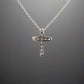 back of white gold cross necklace