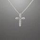 front of white gold diamond cross with 11 small round diamonds