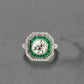 front of diamond ring with emerald gemstones