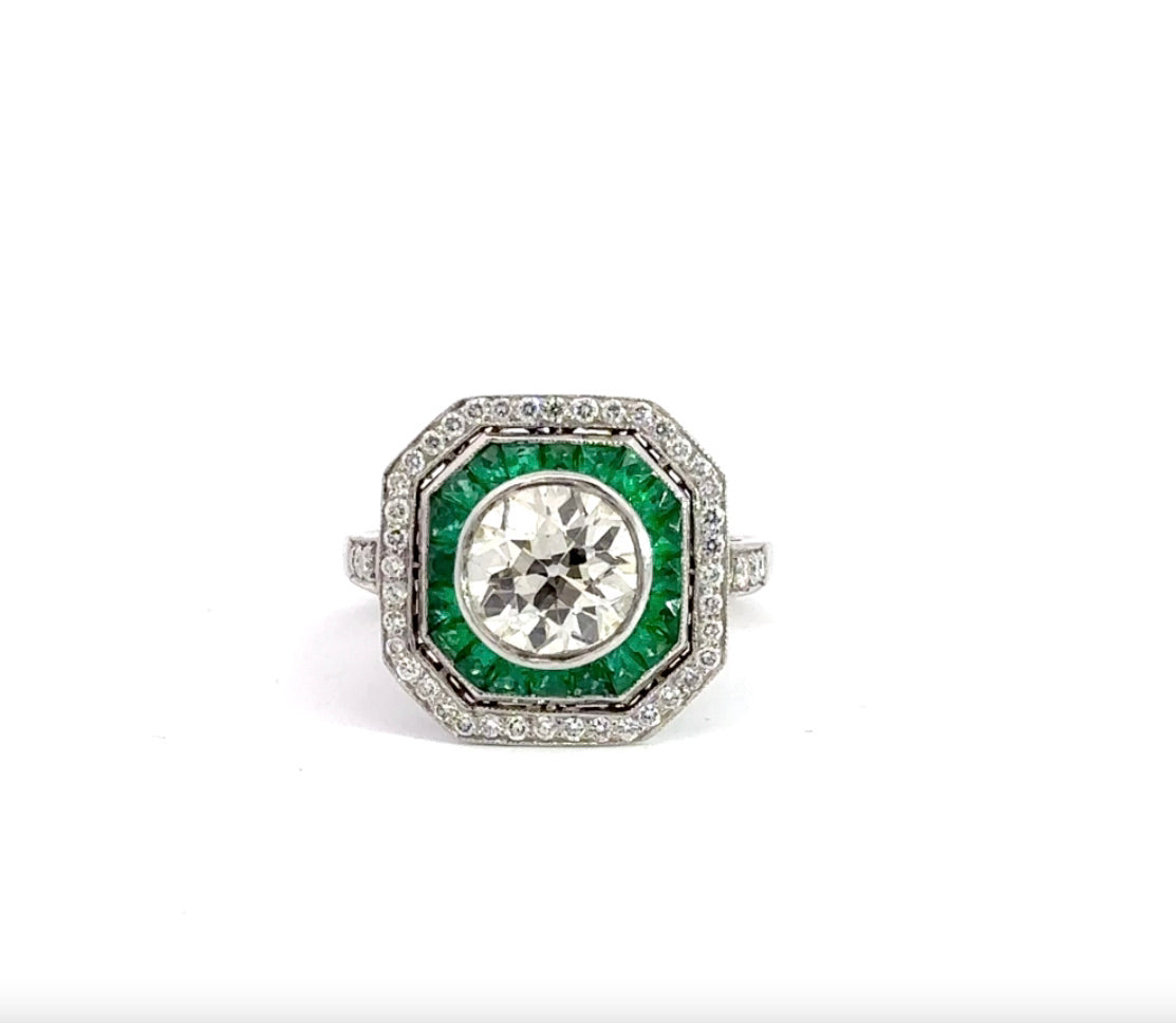 front of diamond ring with emerald gemstones