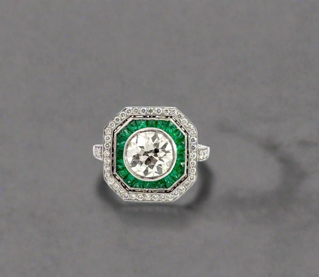 front of diamond ring with emerald gemstones