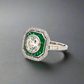 Diagonal view of diamond and emerald ring