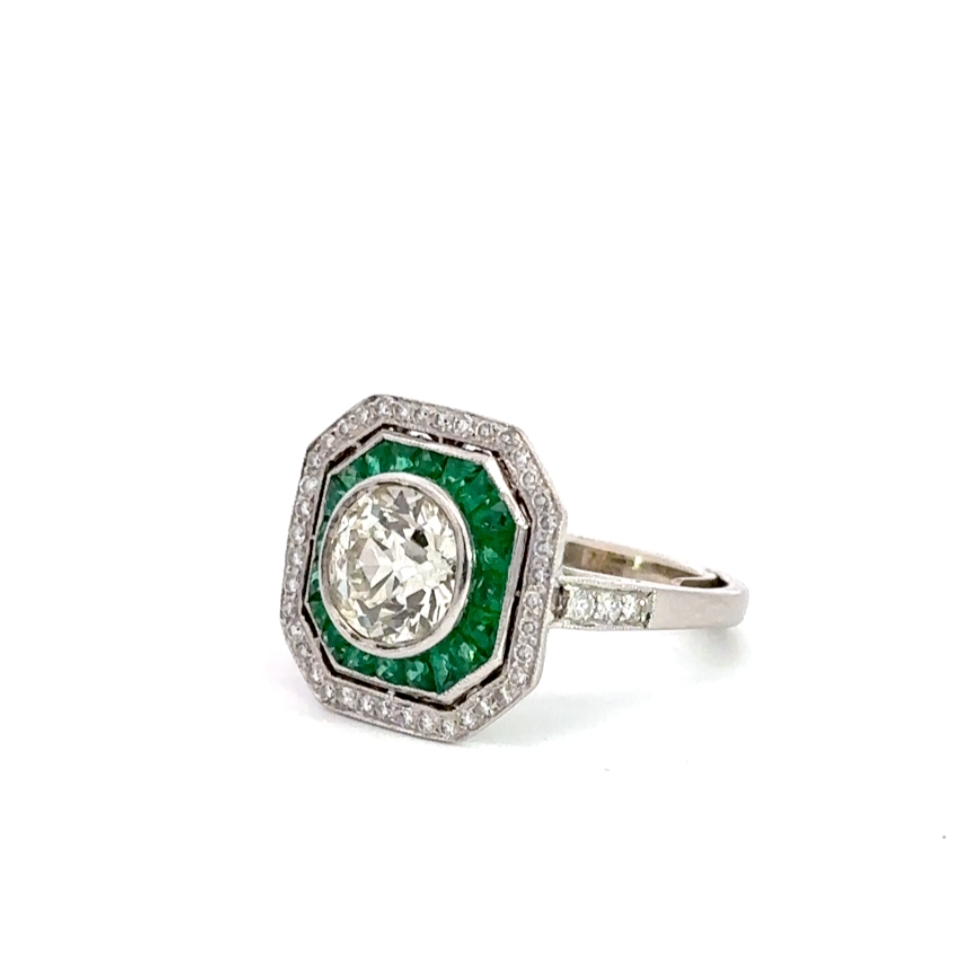 Diagonal view of diamond and emerald ring