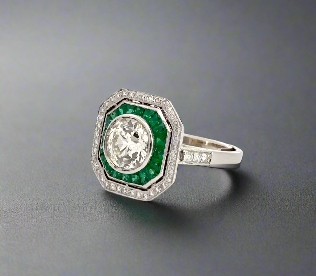 Diagonal view of diamond and emerald ring