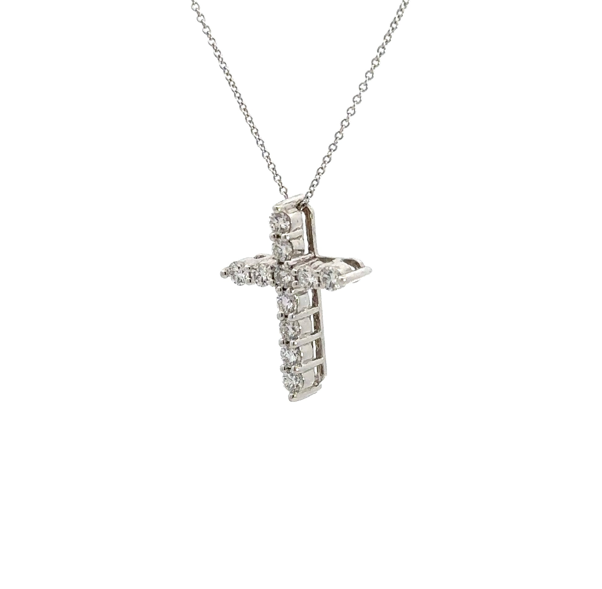 diagonal view of white gold cross necklace