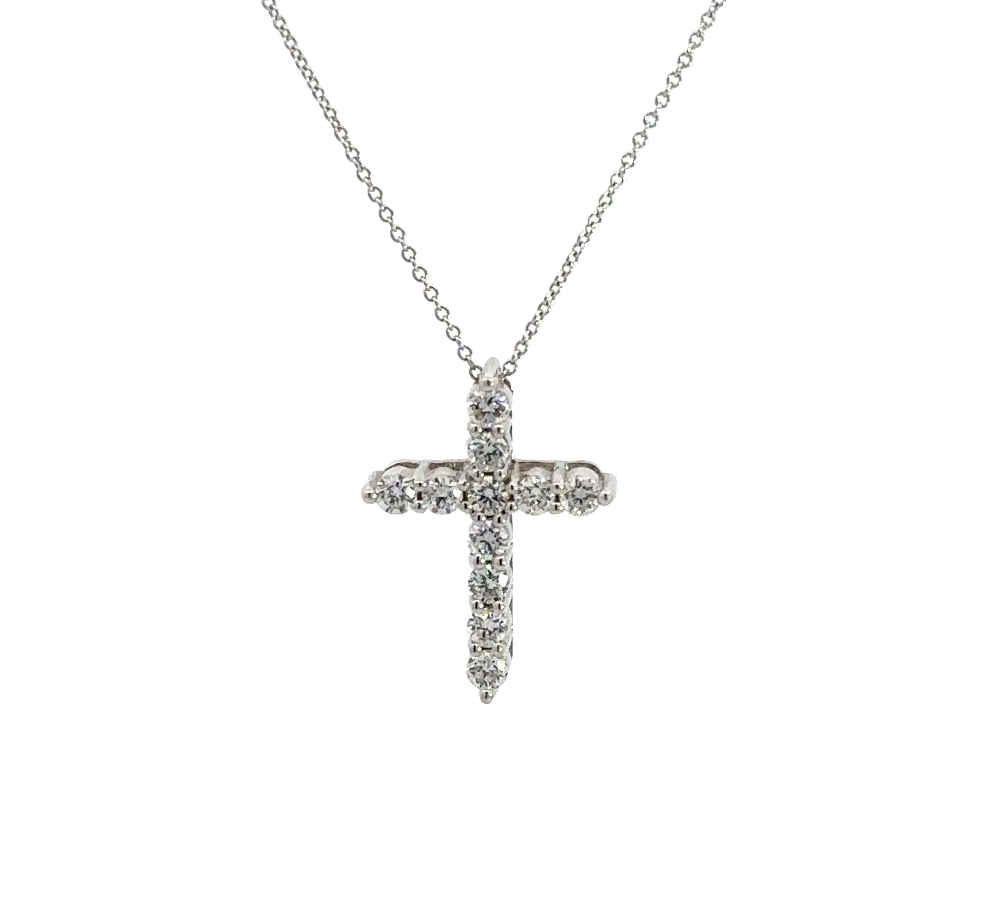 front of white gold diamond cross necklace with 11 small round diamonds
