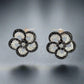 Front of black + white round diamond flower earrings in white gold