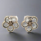 back of white gold diamond flower earrings with 14K stamp on pushbacks