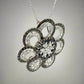 diagonal view of black and white diamond flower necklace