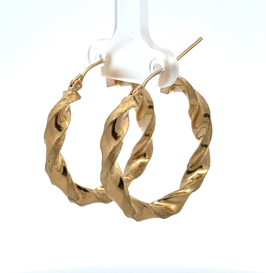 diagonal view of yellow gold twist hoops