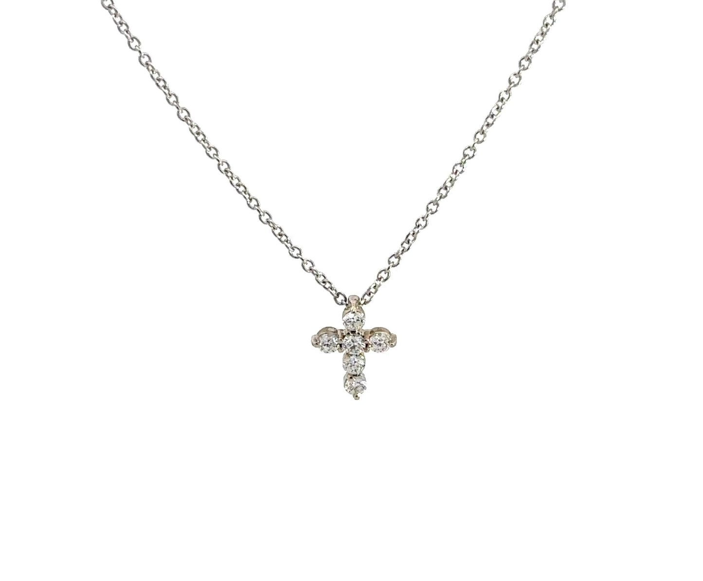 front of mini white gold diamond cross necklace with 6 small round diamonds