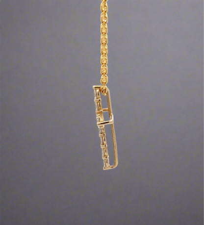 side of yellow gold cross necklace