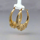 diagonal view of yellow gold shrimp hoops