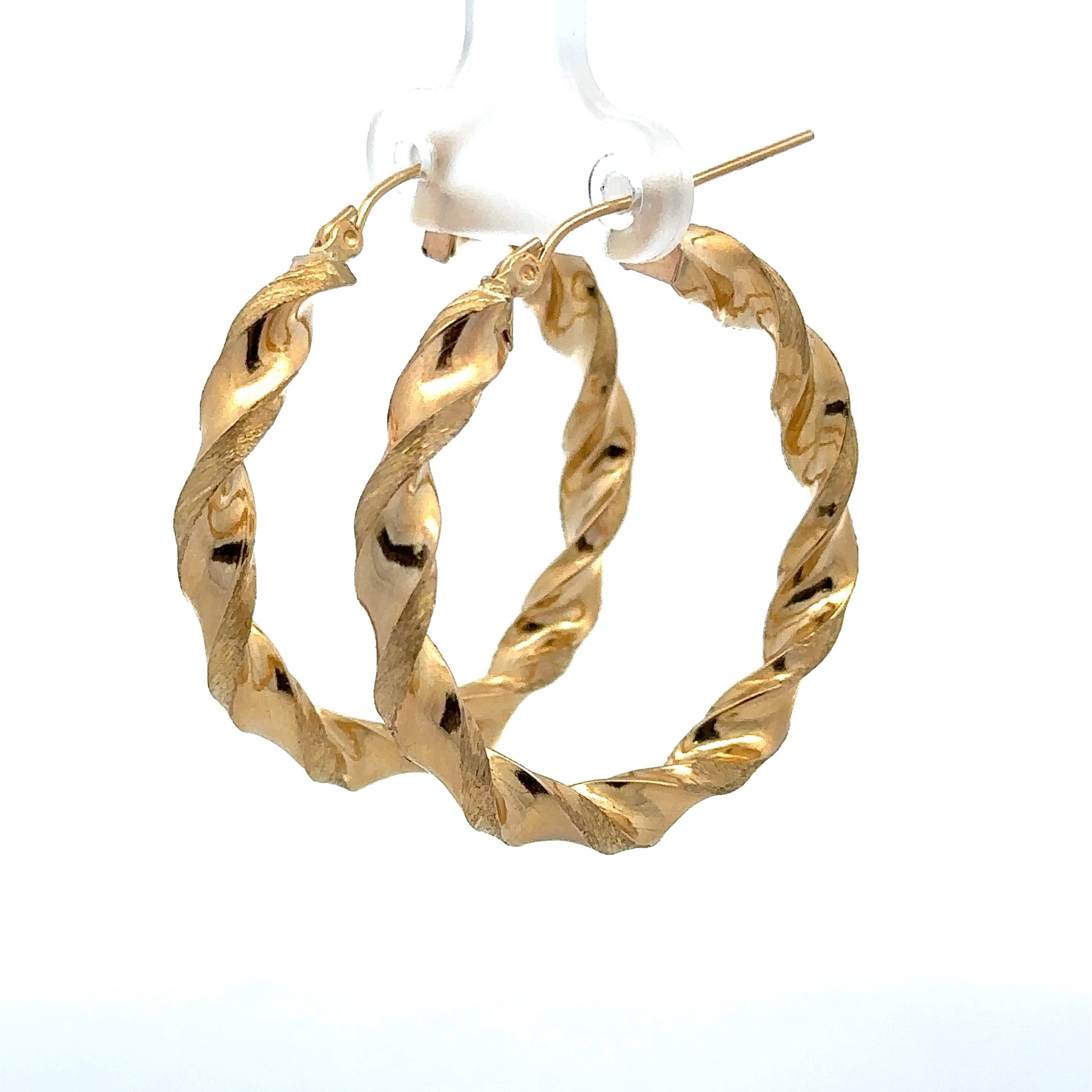 diagonal view of yellow gold twist hoops