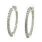 Diagonal view of white gold inside out diamond hoops with round diamonds on front and round diamonds on inside