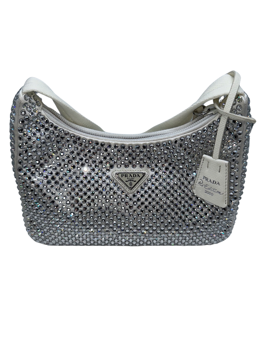 Pictured: The front of the Prada Crystal satin mini bag re-edition in white. It's a small white shoulder bag covered with crystals. No imperfections.