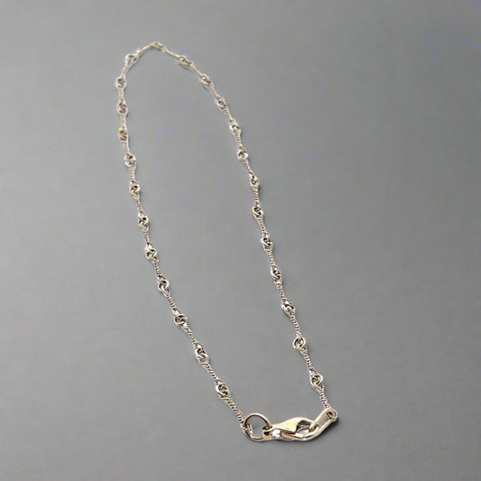 white gold anklet with knot detailing