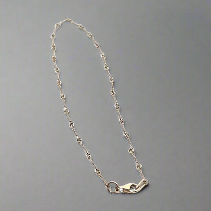 white gold anklet with knot detailing