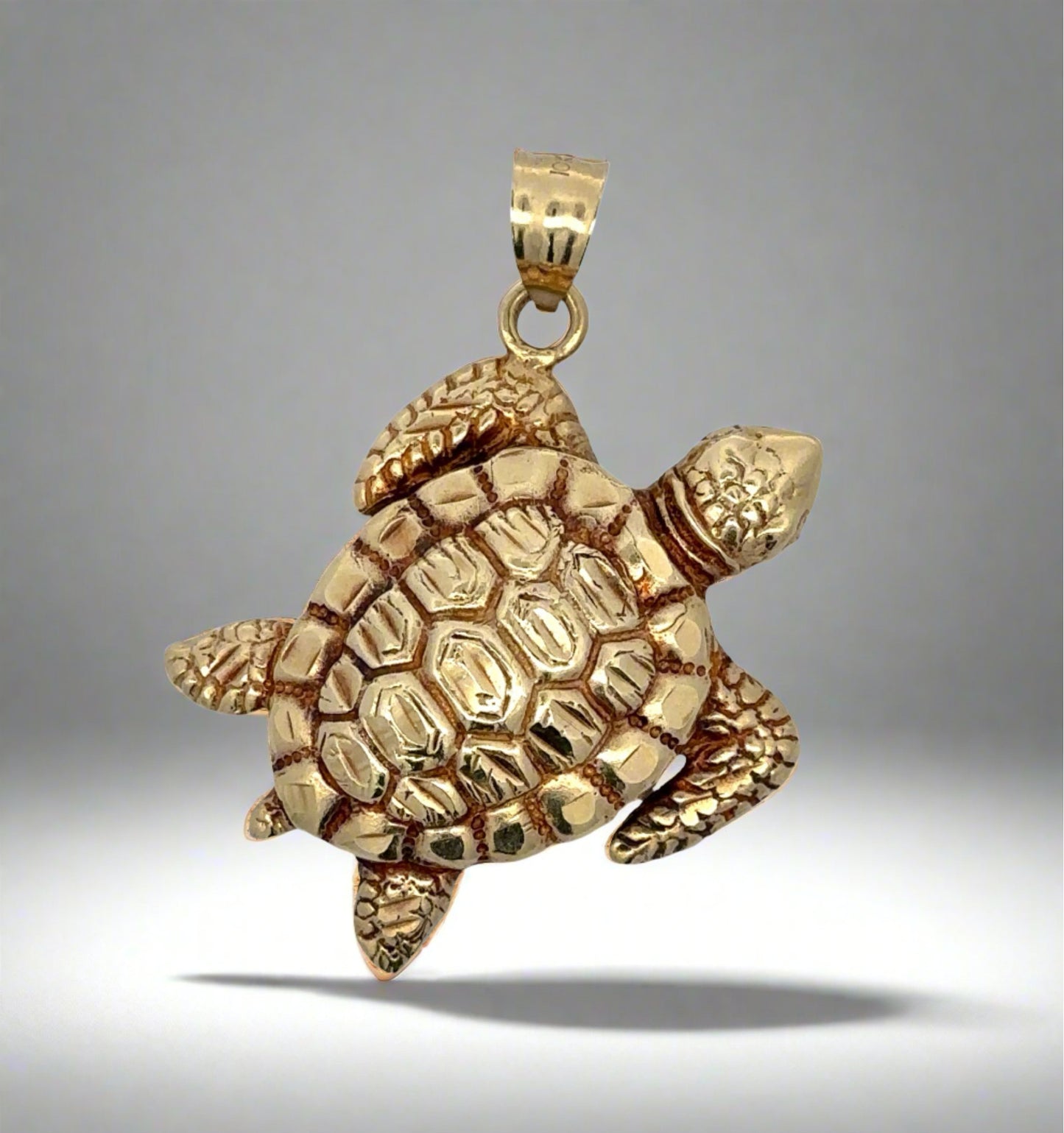 Turtle pendant shown as it would hang on a chain