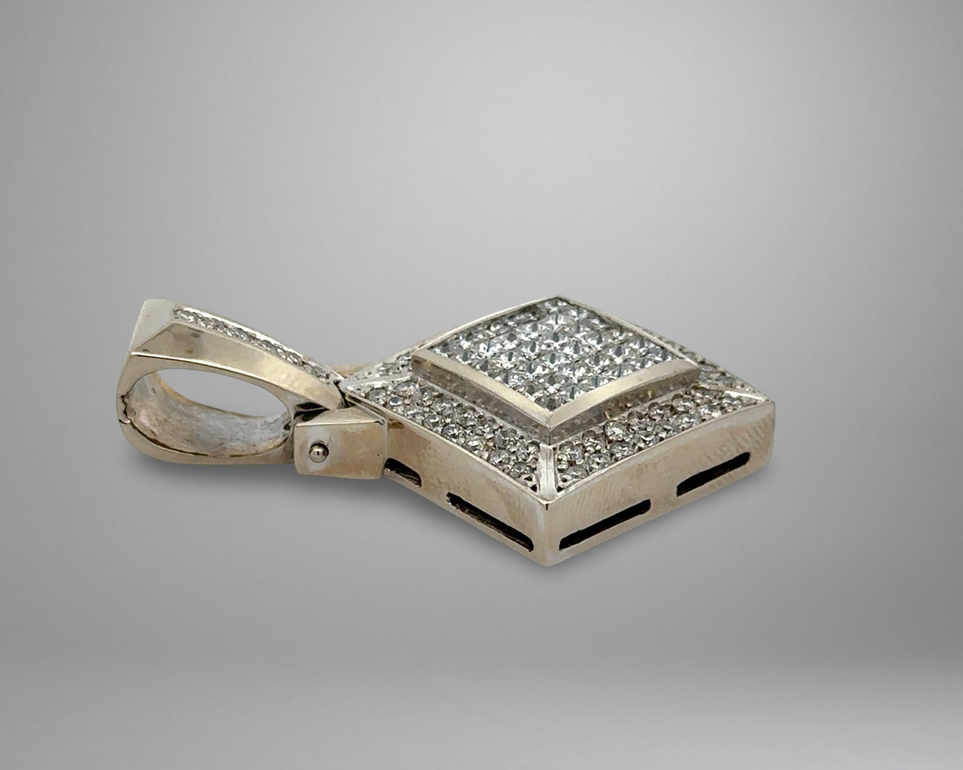 White gold pendant with diamonds on a gray background