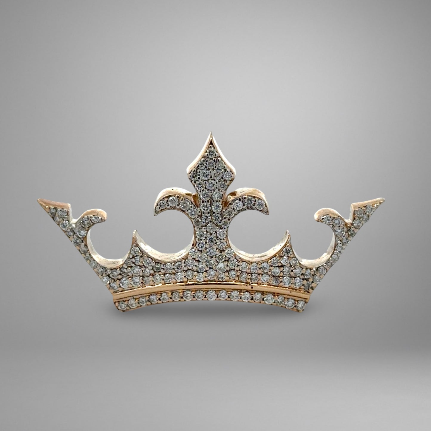 Gold crown with diamond accents on a gray background