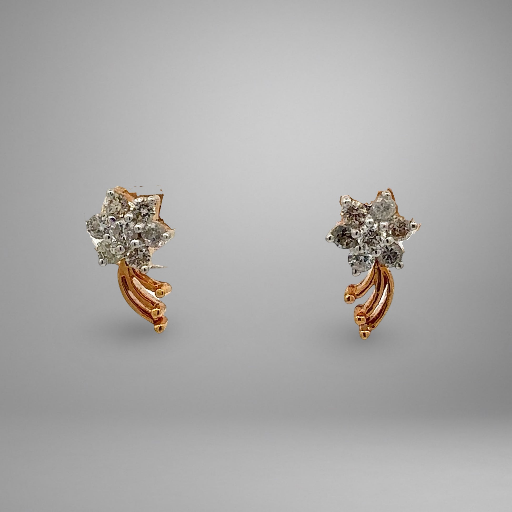 Pair of diamond earrings on a gray background
