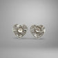 Heart-shaped white gold earrings on a gray background