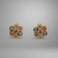 Pair of floral earrings with gold, rose gold, and silver colors on a gray background