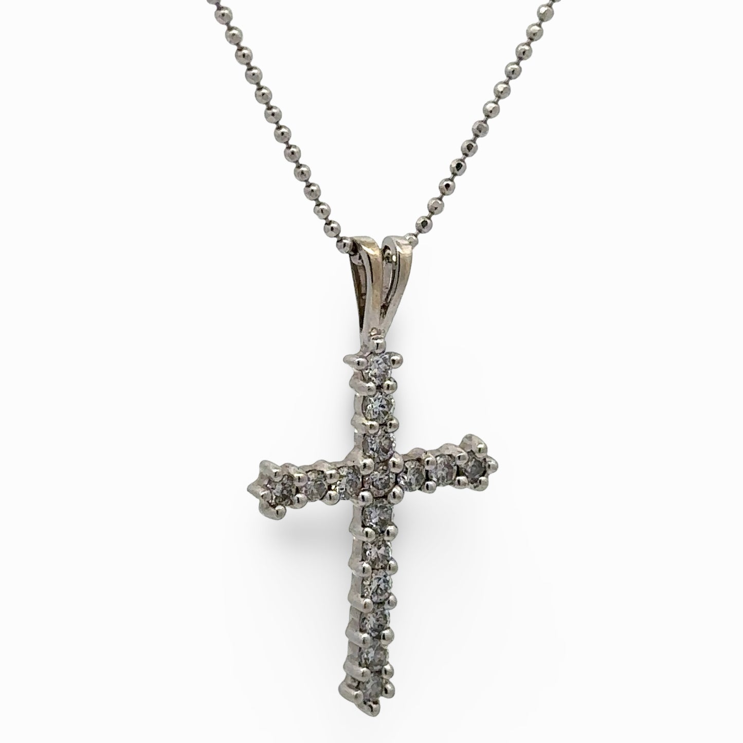 white cross pendant necklace on a white background