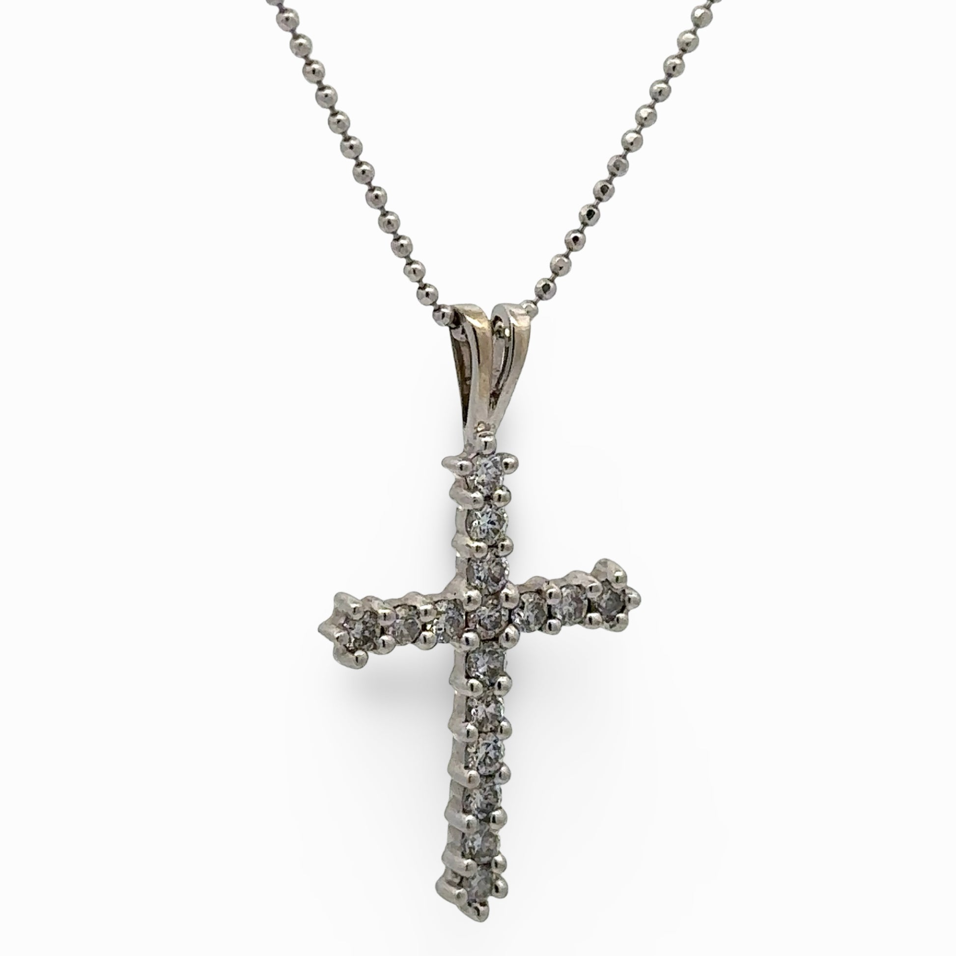 white cross pendant necklace on a white background