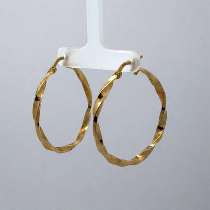 diagonal view of yellow gold twist hoops