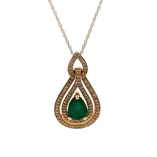 Gold pendant with a green gemstone on a white background
