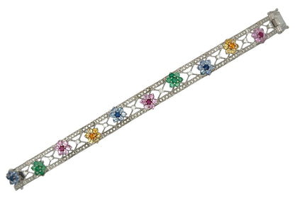 White gold bracelet with colorful gemstones and diamonds on a white background