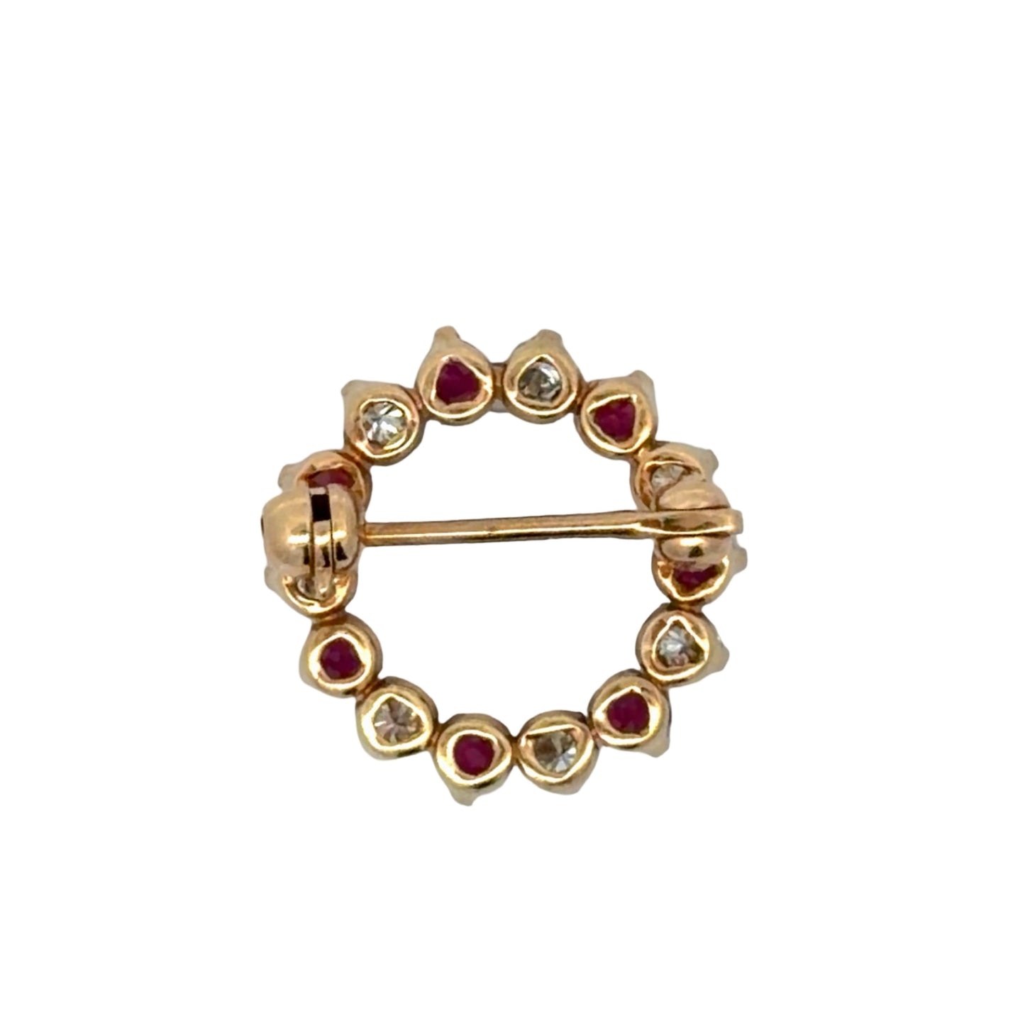 Gold brooch with red gemstones and diamonds on a white background