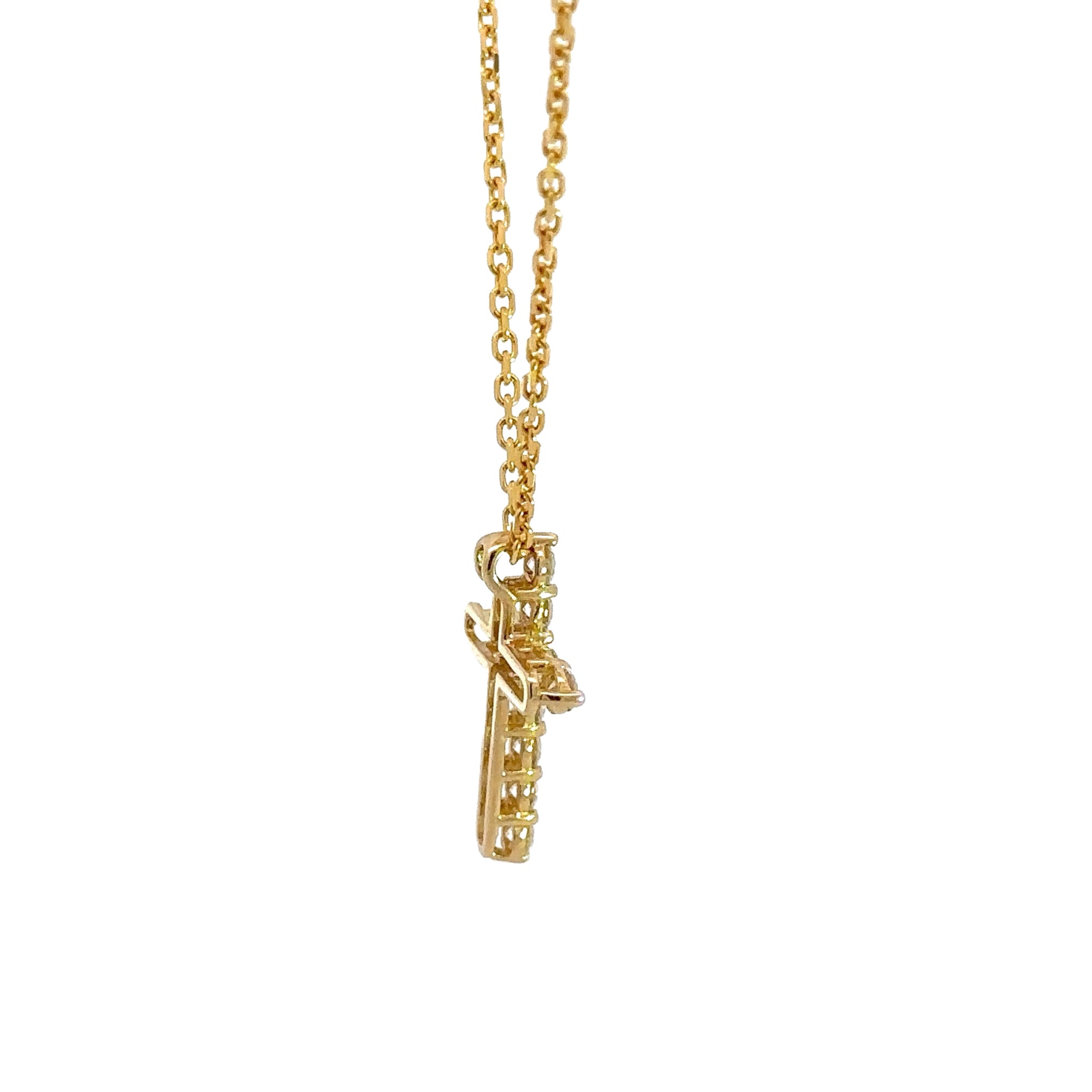 Side of yellow gold diamond cross necklace with open back on cross.