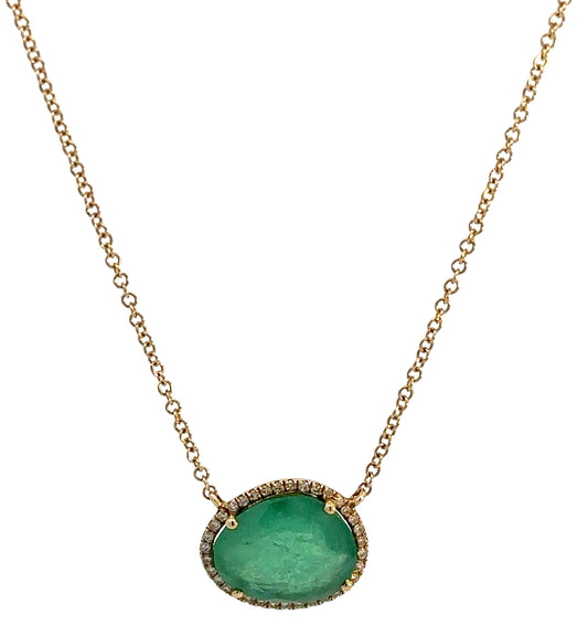 Hanging yellow gold necklace with a free-form emerald and small round diamonds around it